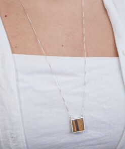 Modelo feminina usando Escapulario Olho de Tigre e Onix Quadrado de prata 925